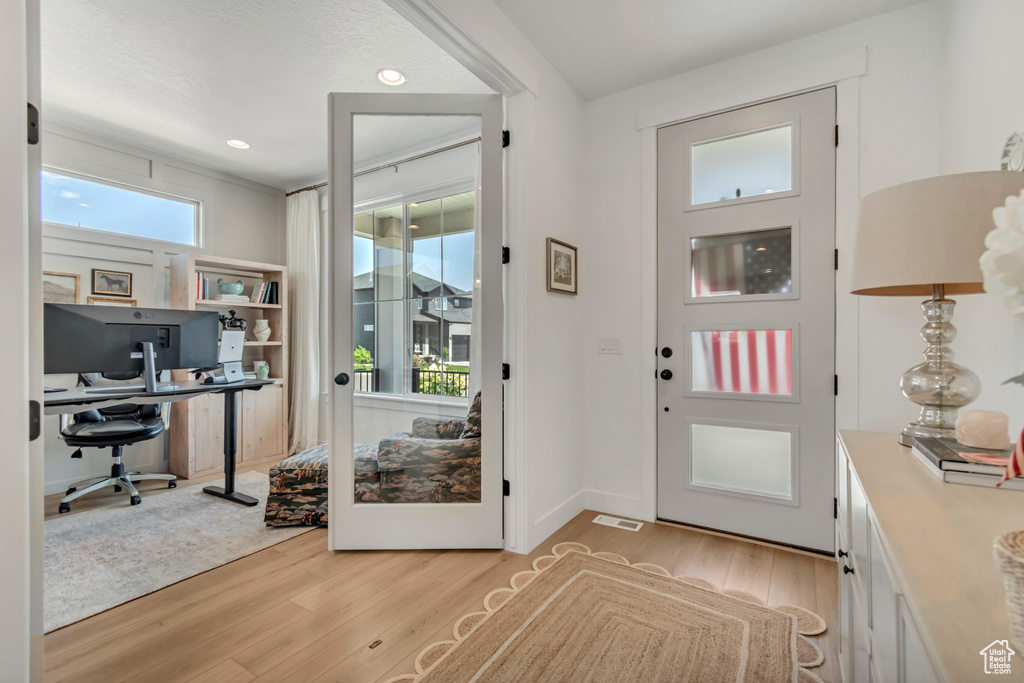 Foyer entrance featuring light wood-style flooring and recessed lighting