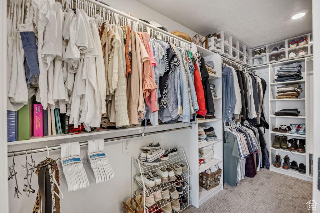Walk in closet with carpet flooring