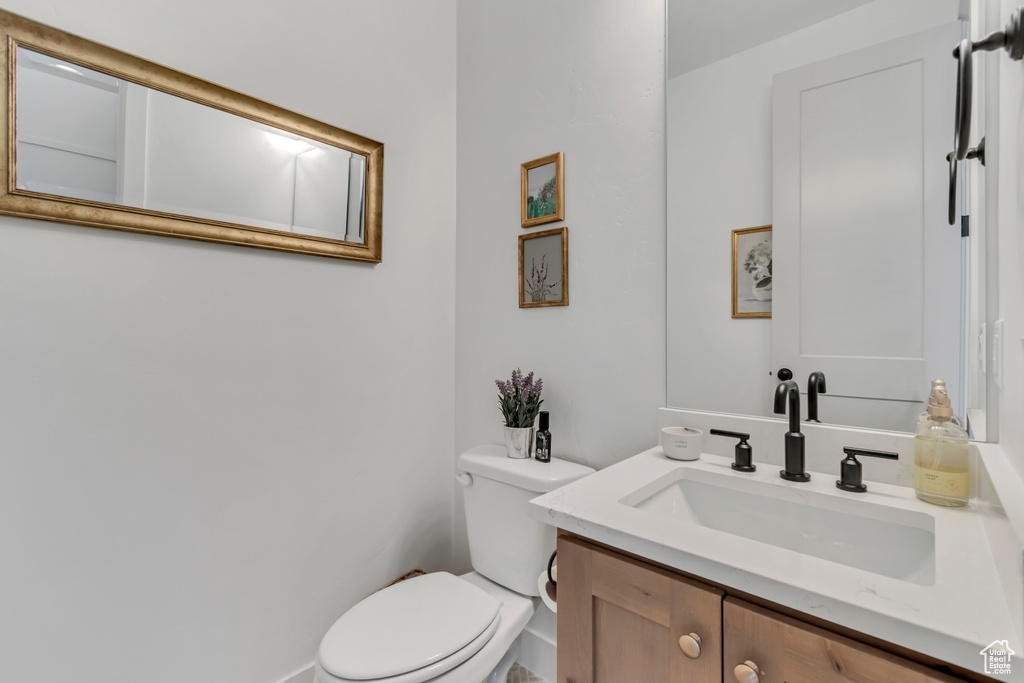 Half bathroom with toilet and vanity