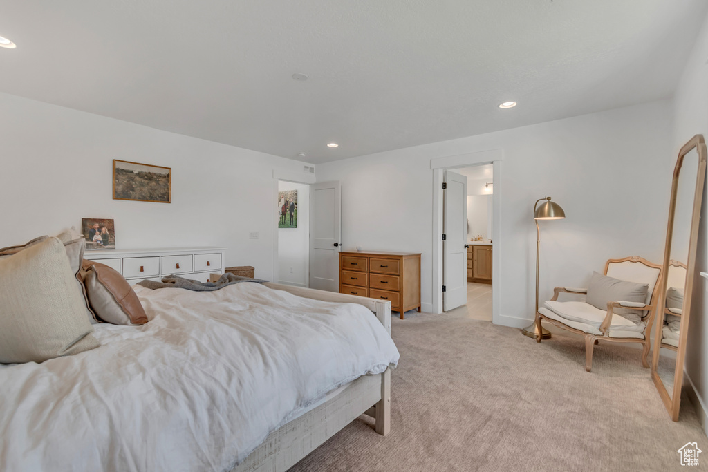 Bedroom with light carpet, recessed lighting, and ensuite bathroom