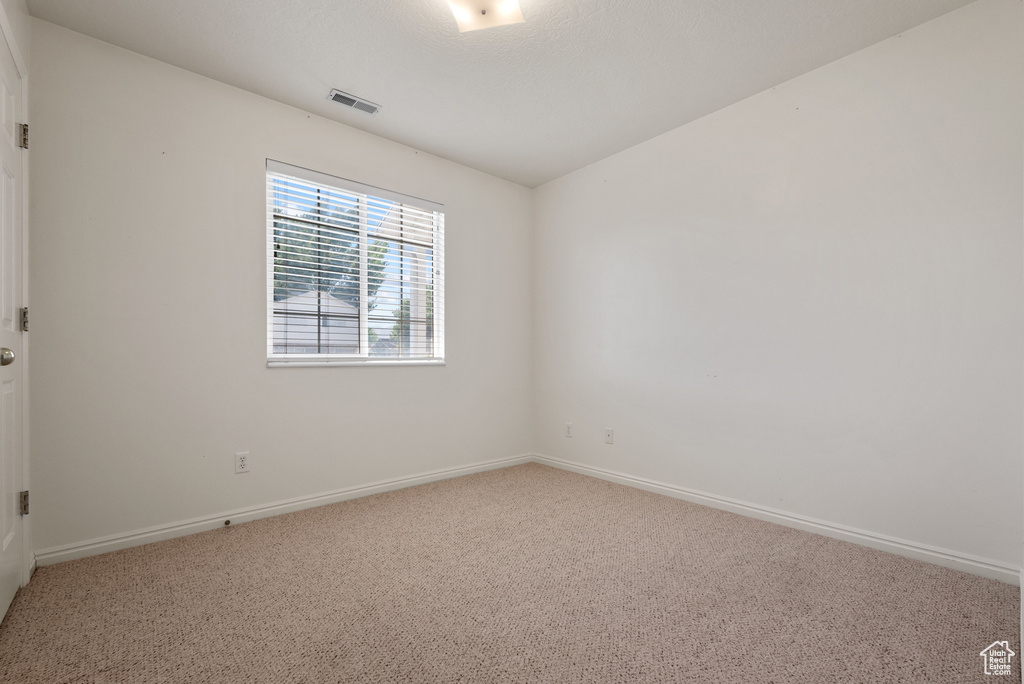 Spare room with carpet floors and baseboards