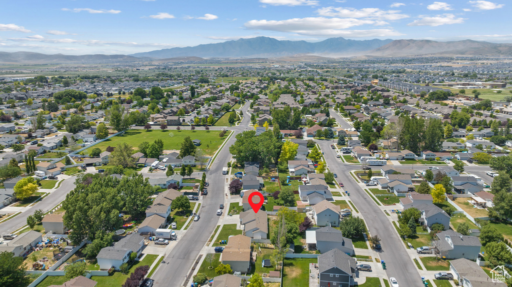 Aerial overview of property's location featuring a mountain backdrop and nearby suburban area