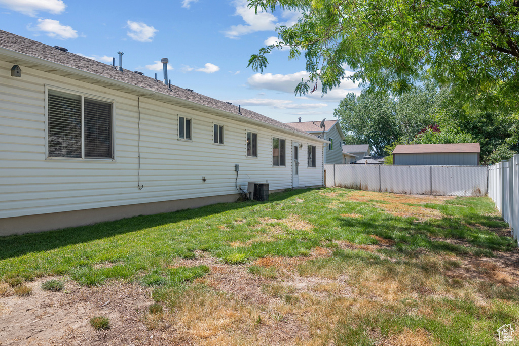 Rear view of house with a fenced backyard