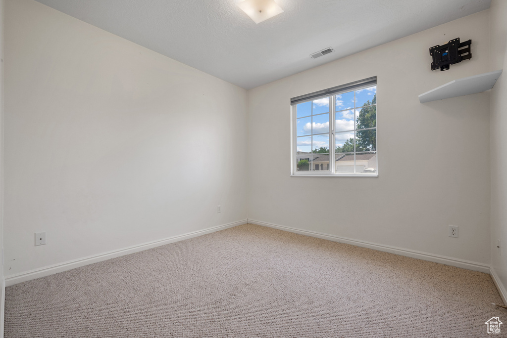 Unfurnished room featuring carpet