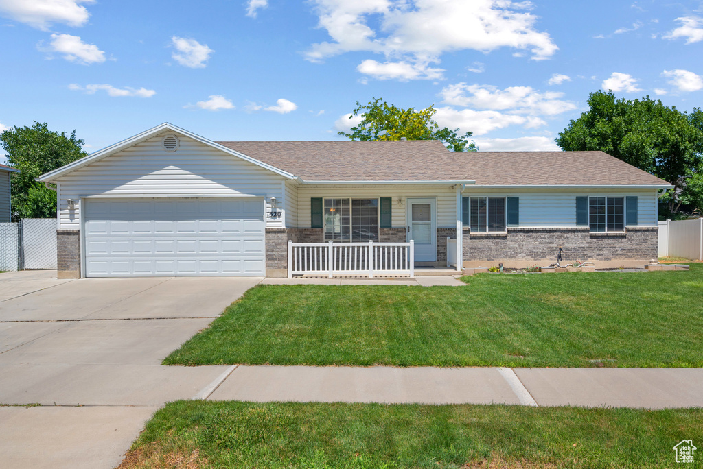 Ranch-style home with brick siding, concrete driveway, an attached garage, and covered porch
