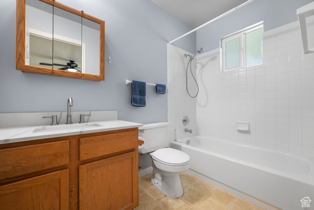 Bathroom with vanity, bathing tub / shower combination, and a ceiling fan