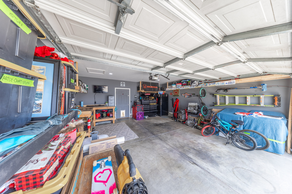 Garage with a workshop area and a garage door opener