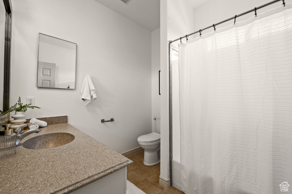Bathroom with vanity, tile patterned flooring, and shower / bathtub combination with curtain