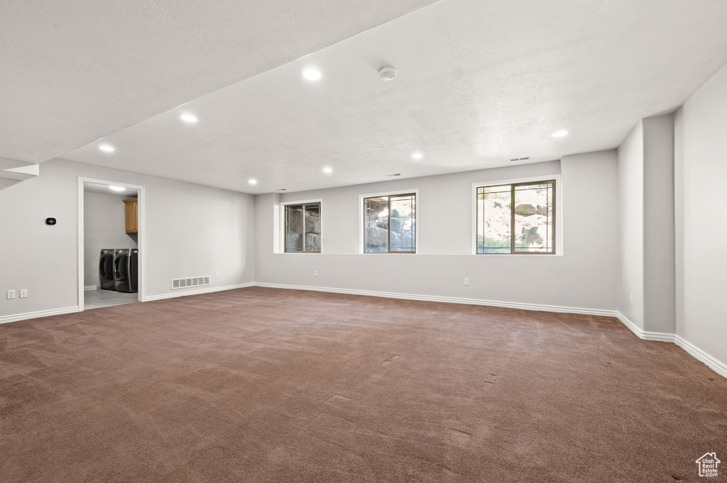 Unfurnished room with independent washer and dryer, carpet flooring, recessed lighting, and a smoke detector