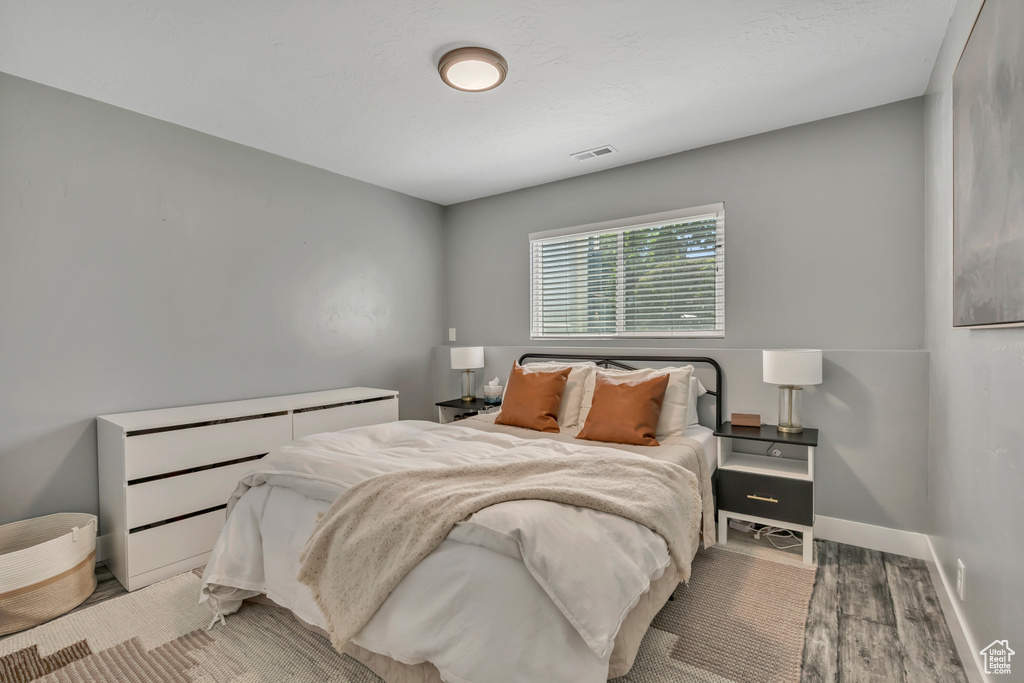 Bedroom featuring light wood-type flooring and baseboards