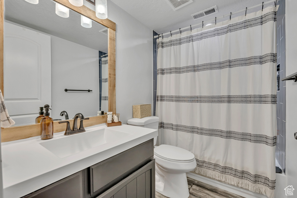 Full bath featuring vanity and shower / bath combination with curtain
