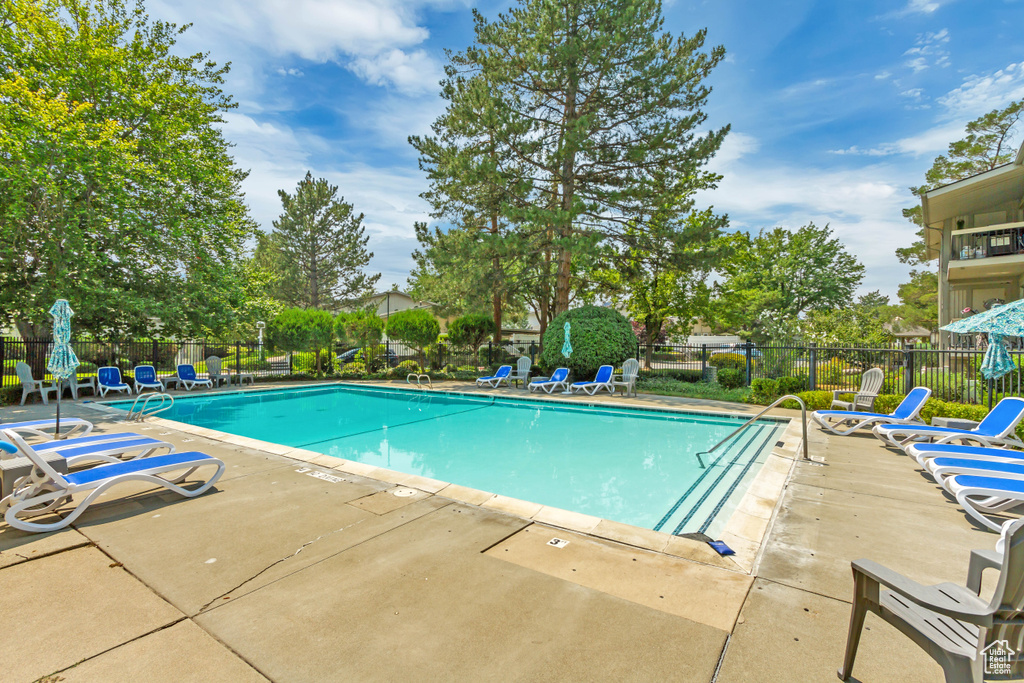 Community pool featuring a patio