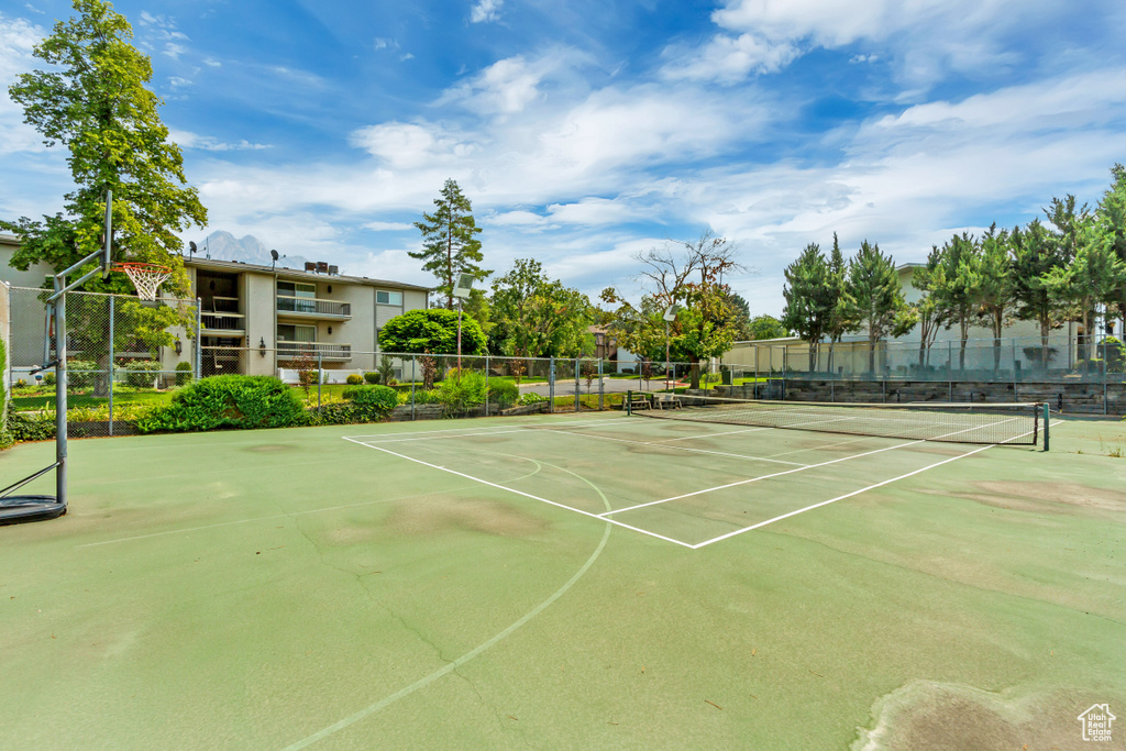 View of tennis court with community basketball court