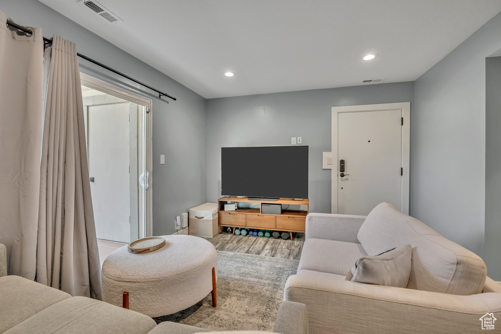 Living room with wood finished floors and recessed lighting