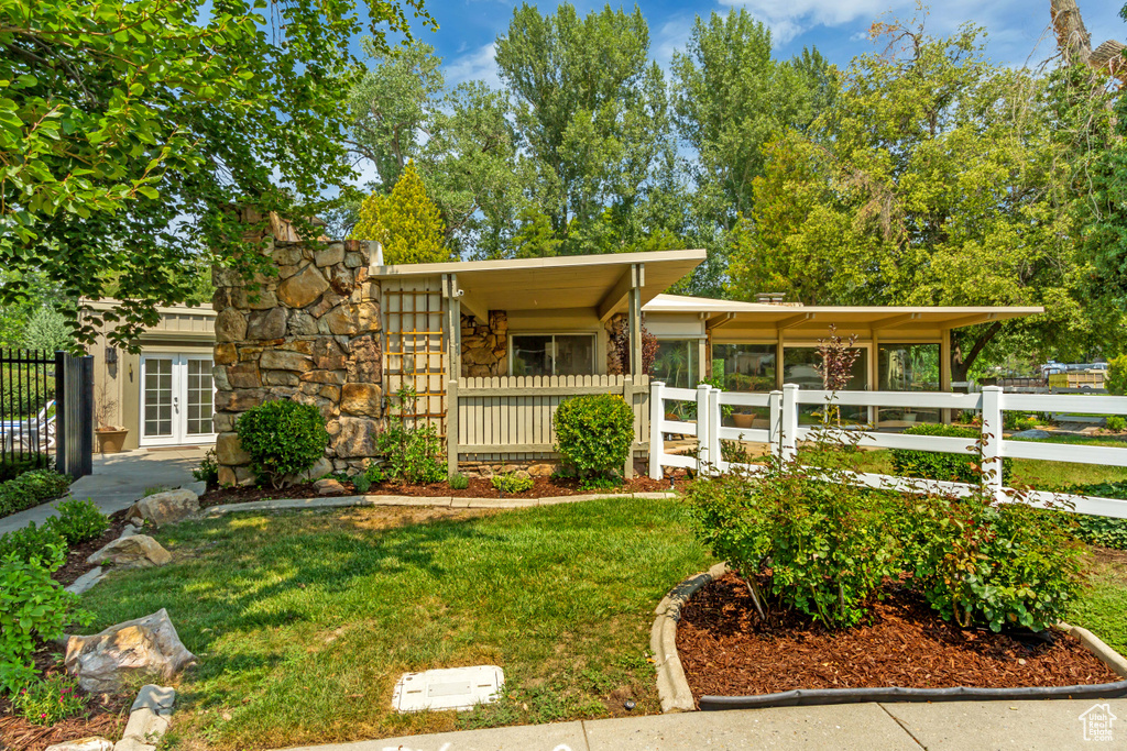 View of front of home featuring french doors and stone siding