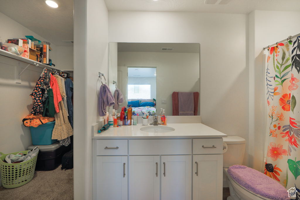 Full bathroom featuring vanity, a shower with curtain, and recessed lighting