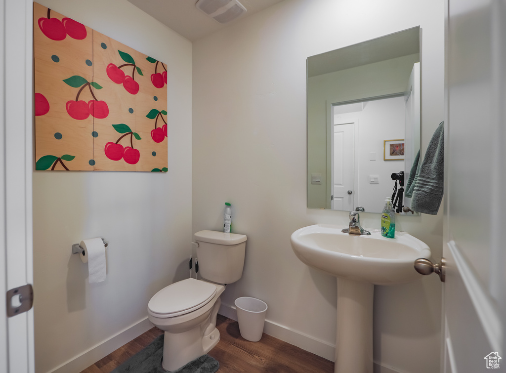 Bathroom with baseboards and wood finished floors