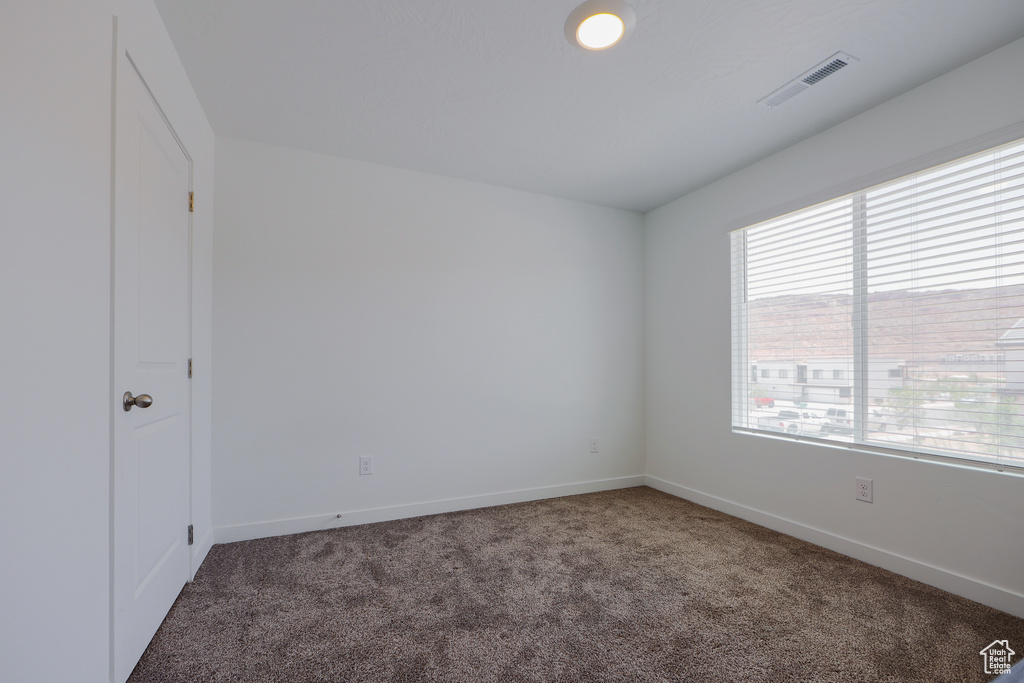 Unfurnished bedroom with carpet flooring and baseboards