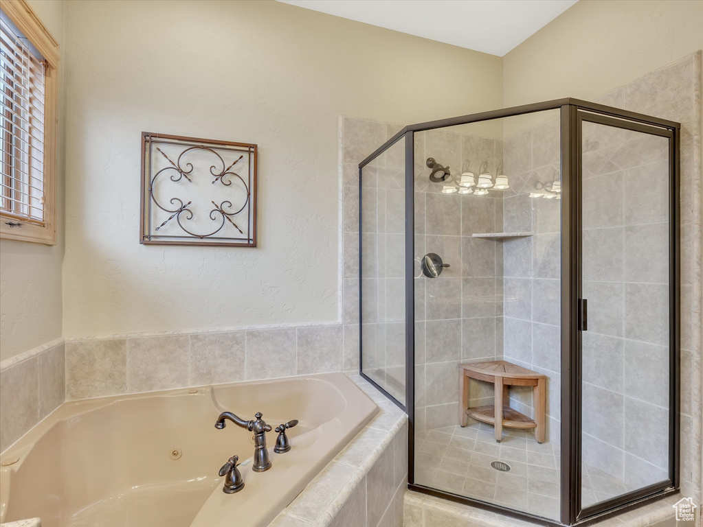 Full bathroom featuring a shower stall and a jetted tub