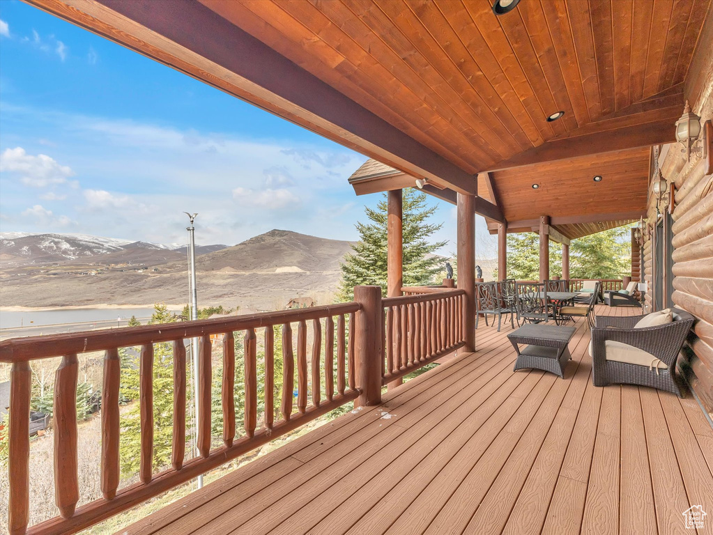 Deck featuring a mountain view and outdoor dining space
