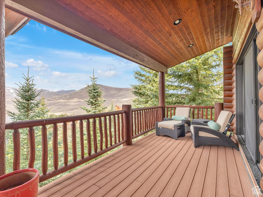Wooden deck with a mountain view and outdoor lounge area