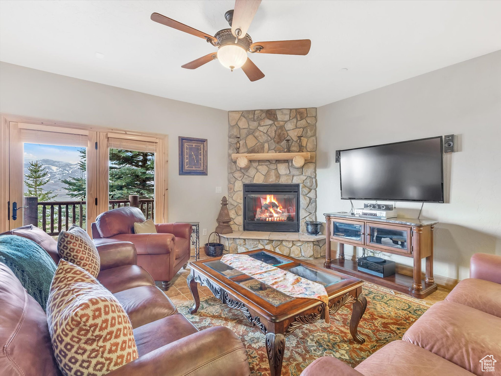 Living room featuring a fireplace and ceiling fan