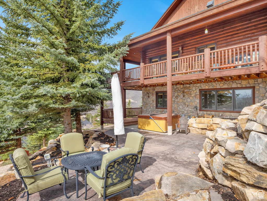 Patio / terrace with a hot tub and a patio area