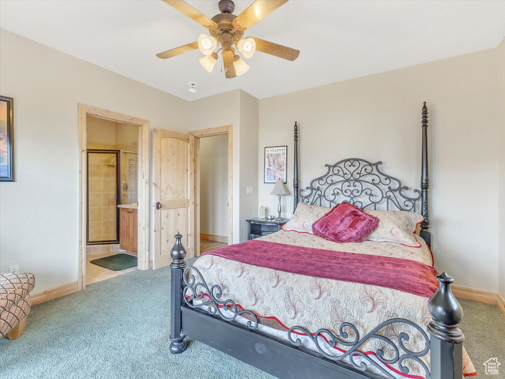 Bedroom featuring carpet flooring, ceiling fan, and ensuite bathroom