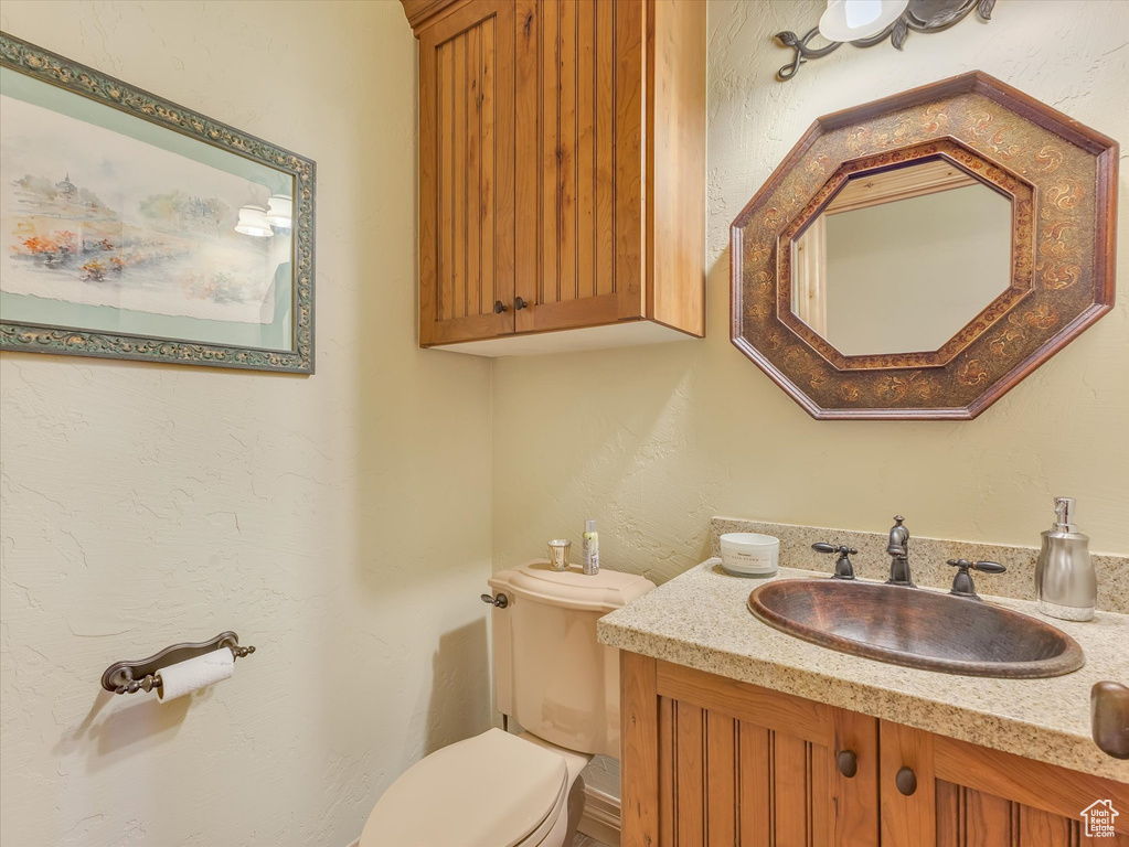 Half bathroom with toilet and vanity