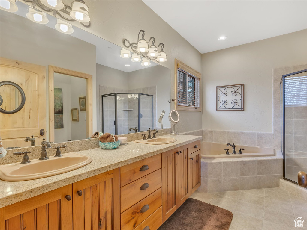 Bathroom with tile patterned flooring, a stall shower, double vanity, and a bath
