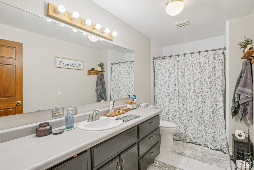 Bathroom with tile patterned flooring, vanity, and a shower with shower curtain