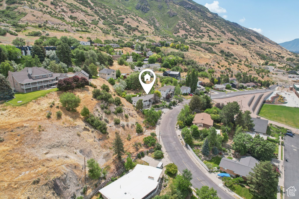 Aerial overview of property\\\'s location with a mountainous background and nearby suburban area