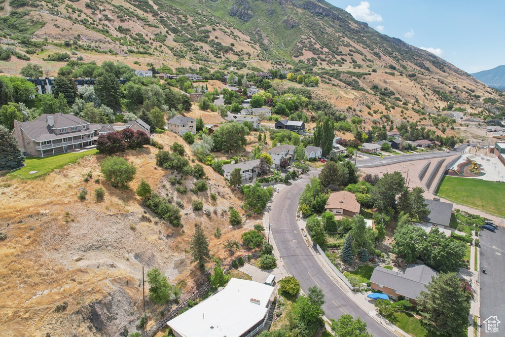 Aerial overview of property\\\'s location featuring a mountain backdrop and nearby suburban area