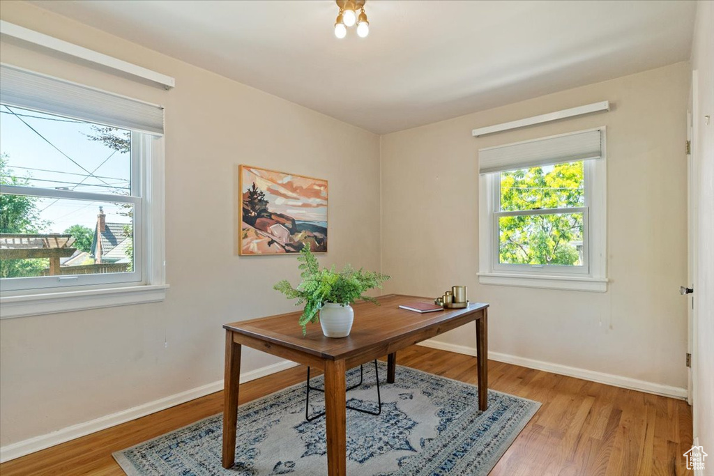 Office with healthy amount of natural light and light wood-style floors