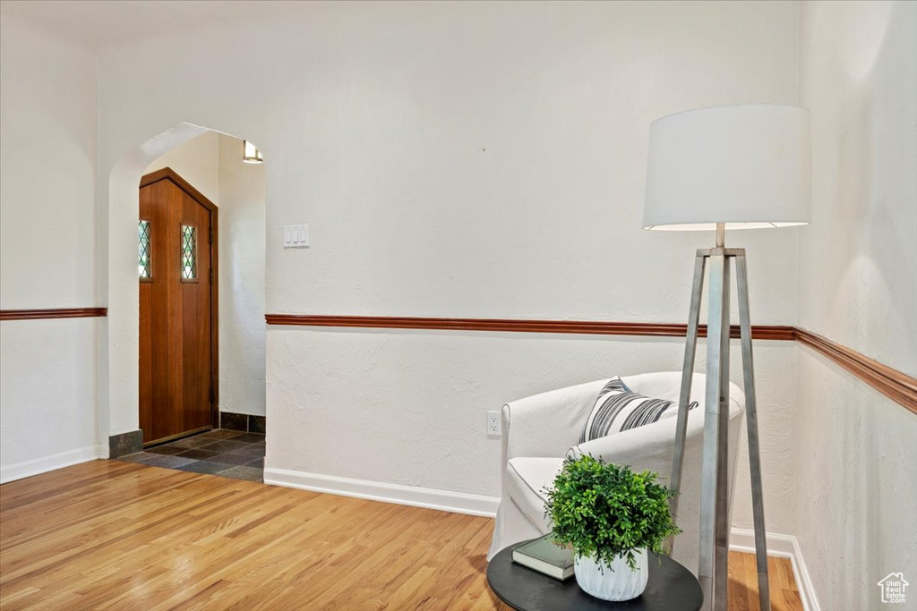 Foyer entrance with arched walkways and wood finished floors