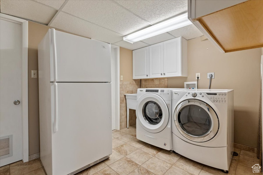 Laundry area featuring cabinet space and washer and dryer