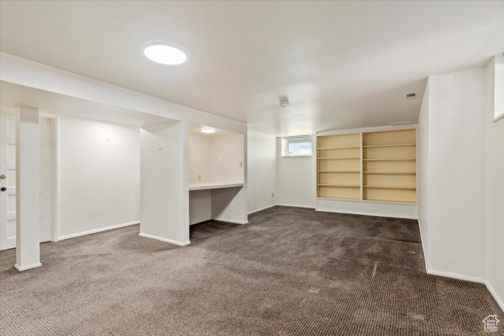 Basement with dark colored carpet