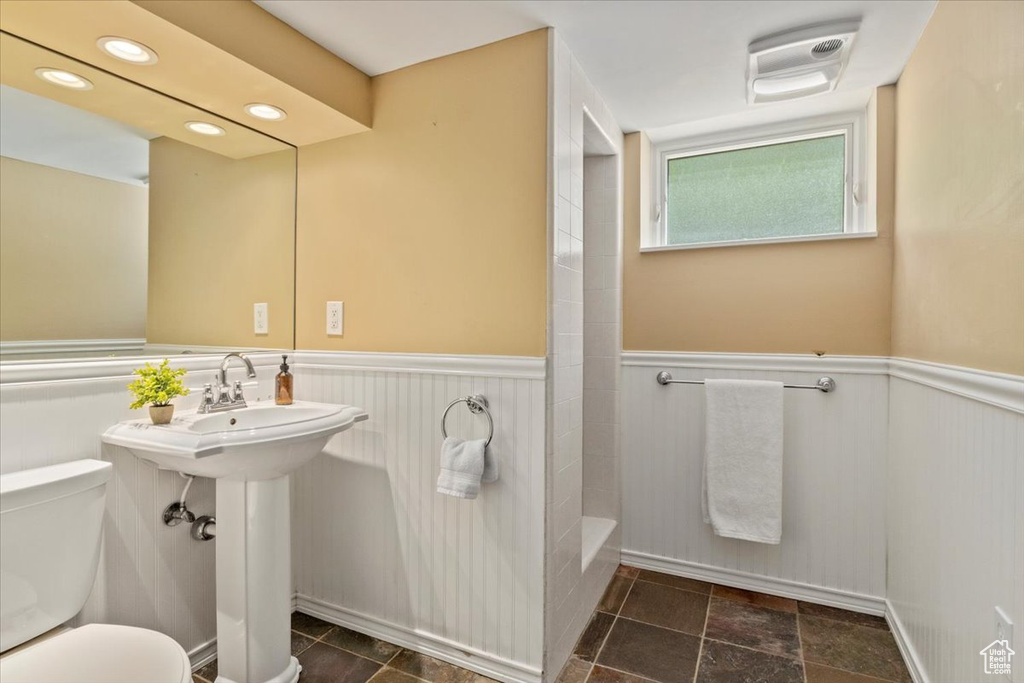 Bathroom with a wainscoted wall and recessed lighting