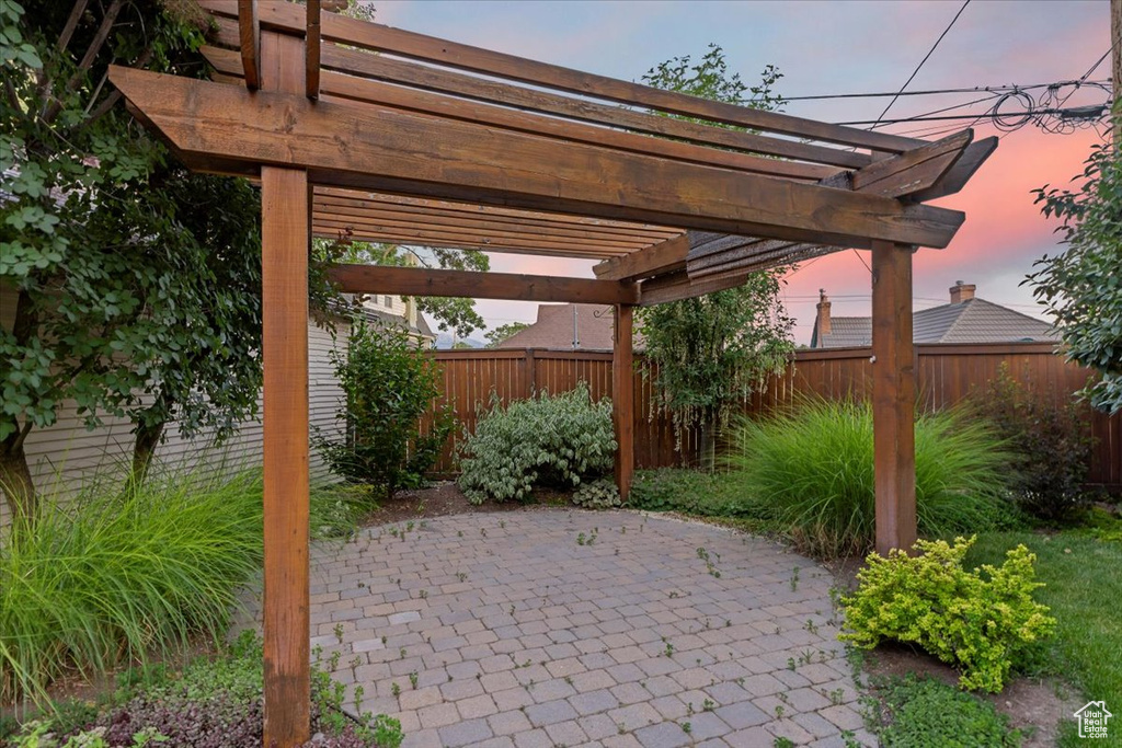Fenced backyard with a pergola and a patio