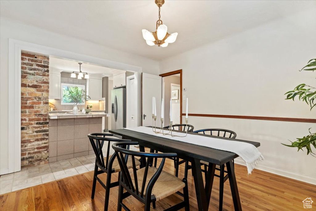 Dining area with a chandelier and light wood-style floors
