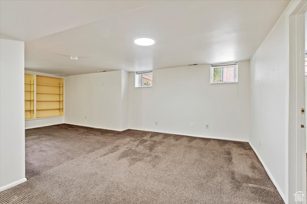 Below grade area featuring carpet and baseboards
