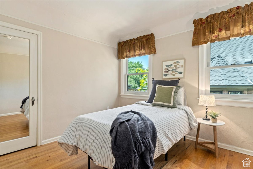 Bedroom with baseboards and wood finished floors