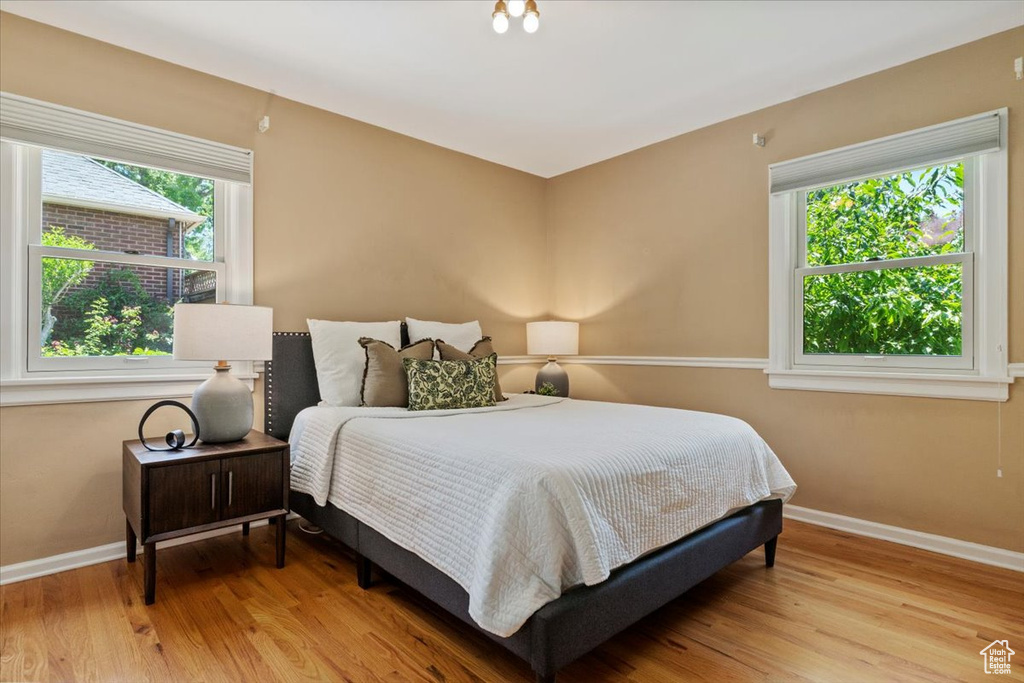 Bedroom featuring light wood finished floors and baseboards