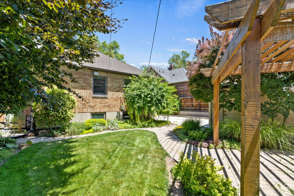 View of green lawn with a patio area