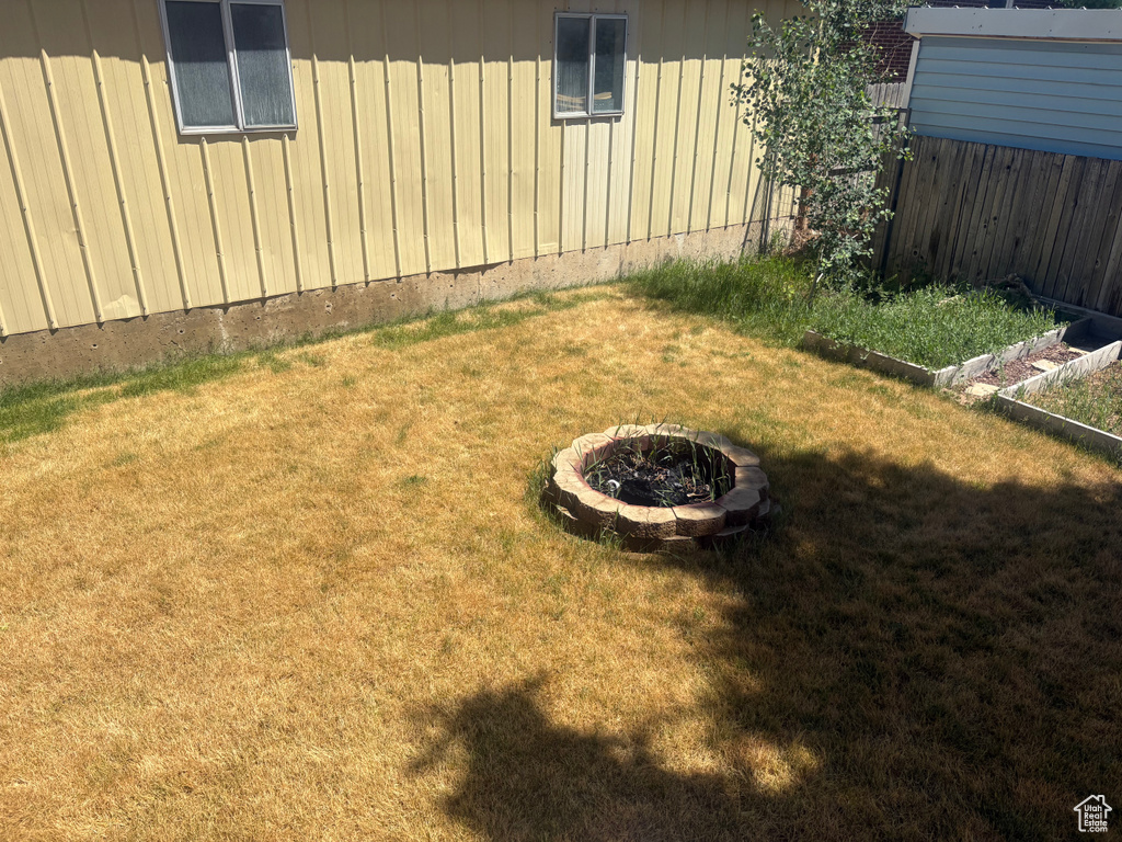 View of yard with an outdoor fire pit