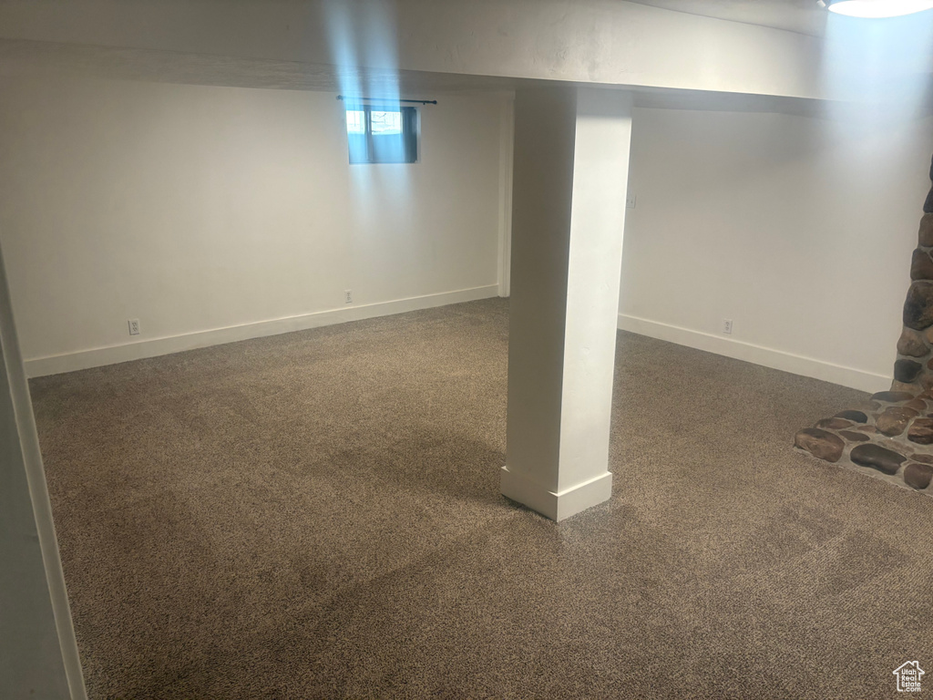Basement with dark carpet