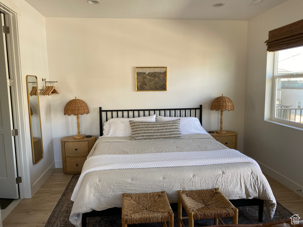 Bedroom featuring wood finished floors and baseboards