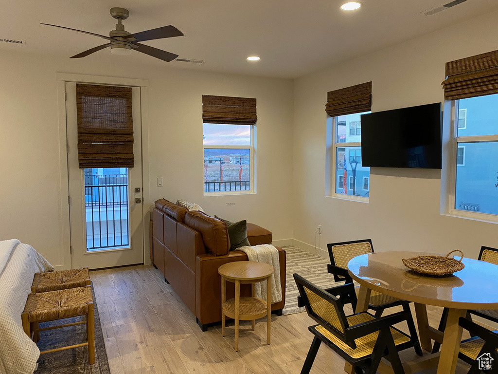 Living room featuring healthy amount of natural light, light wood-type flooring, recessed lighting, and a ceiling fan