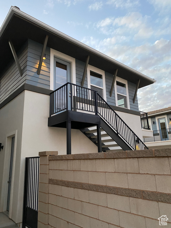 View of home's exterior featuring a balcony and stucco siding