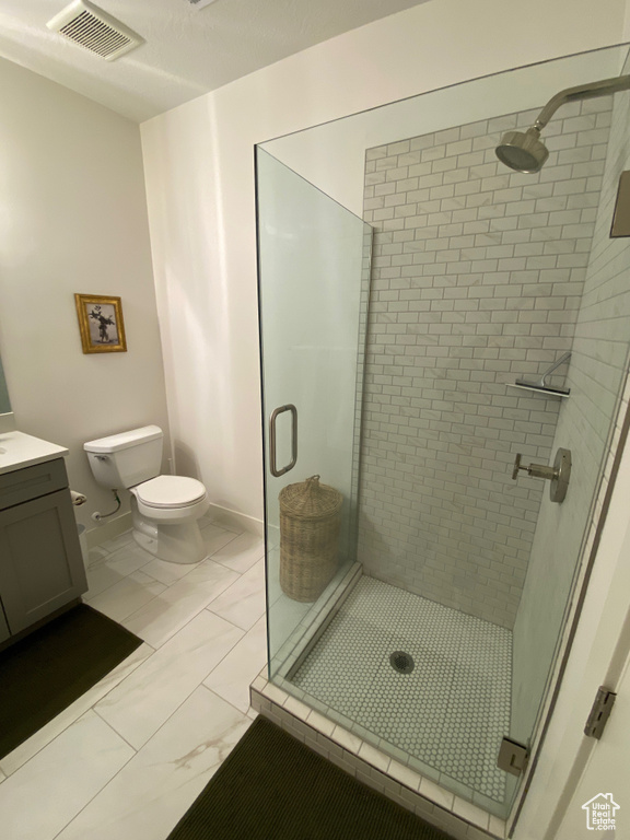 Bathroom with a stall shower, vanity, and marble finish floors